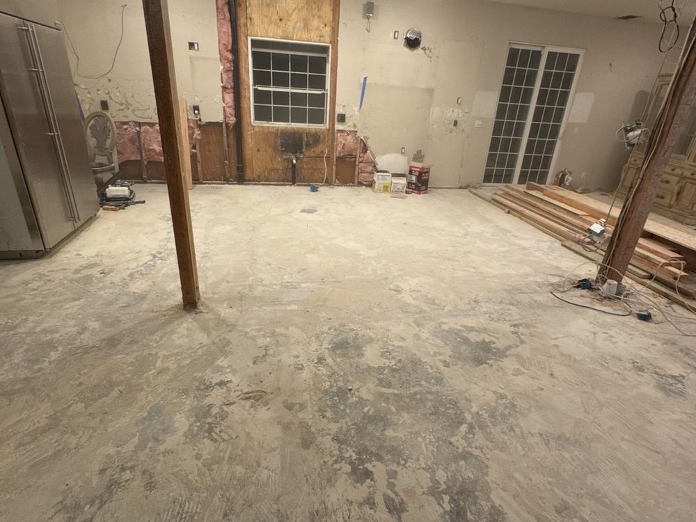 The same gutted kitchen broom-clean after our team hauled the debris