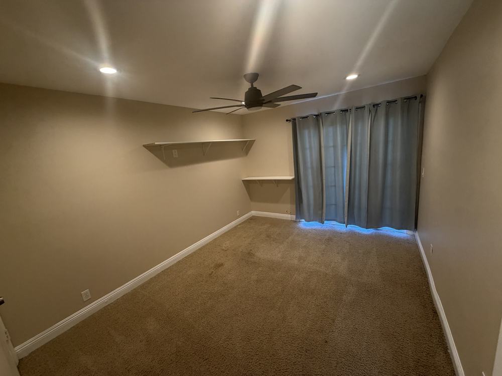 The same bedroom cleared to bare carpet after removal