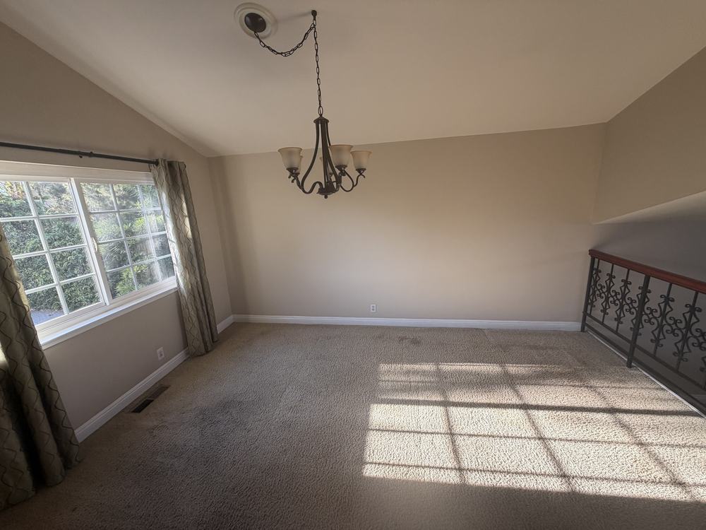 The same dining nook cleared to bare carpet after removal