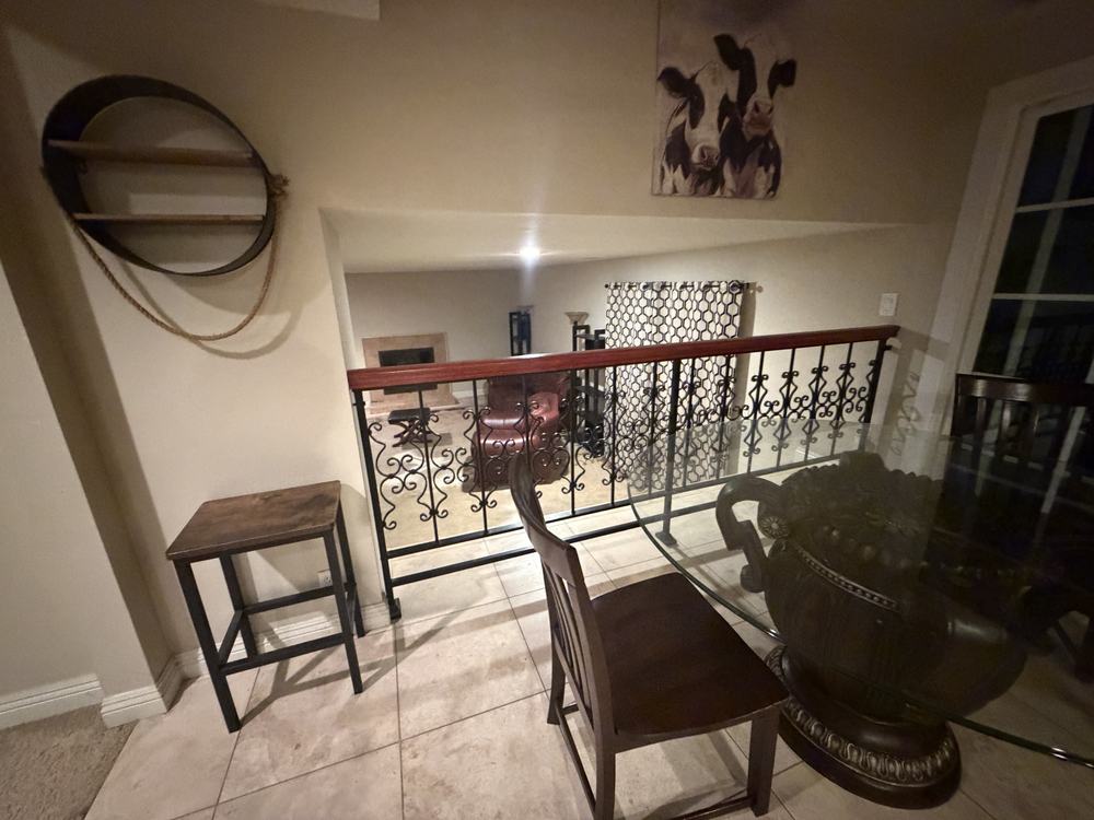 Family room with a glass table, chairs and a side table before removal