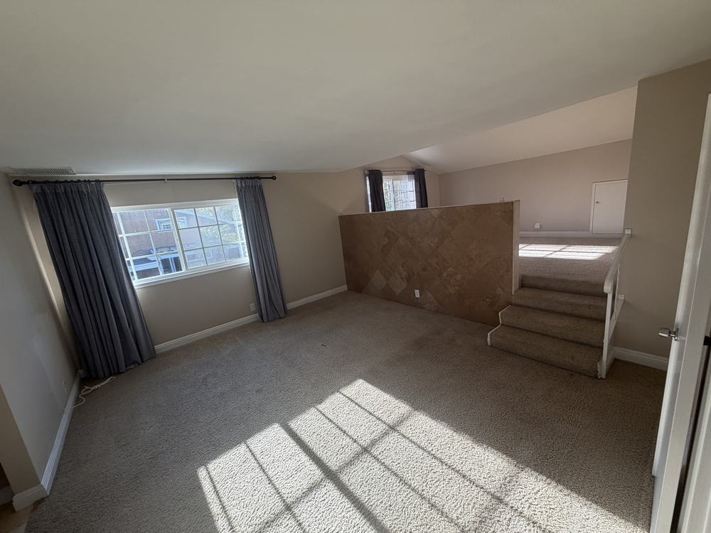 The same loft bedroom empty after our team removed the furniture