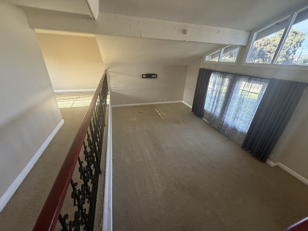 The same loft living room empty and swept after our team removed the furniture