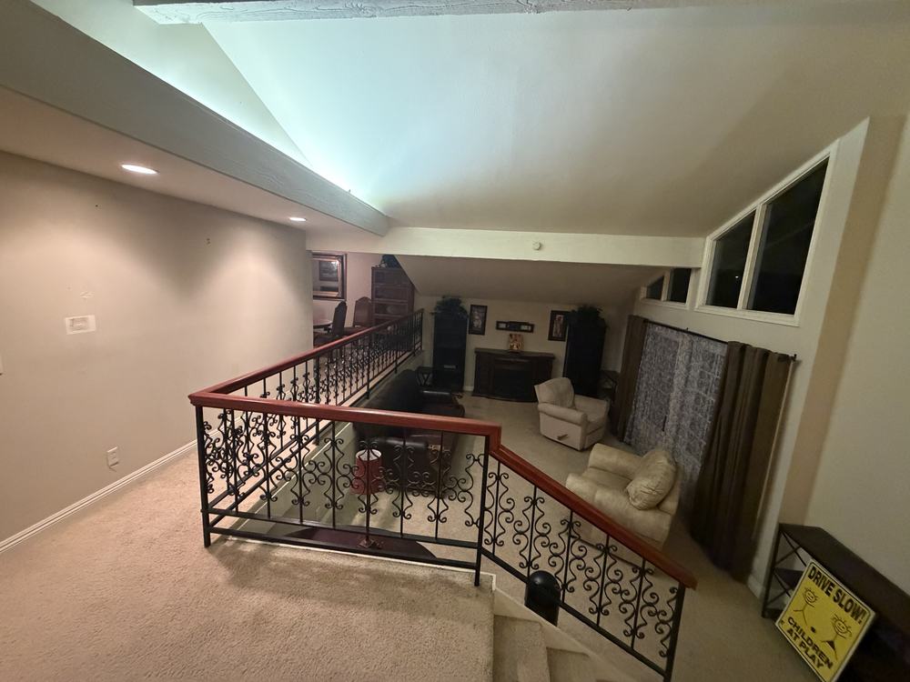 Loft living room furnished with sofas, armchairs and a TV console before removal