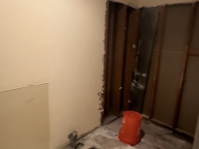 The same bathroom swept to the slab after our team removed the debris