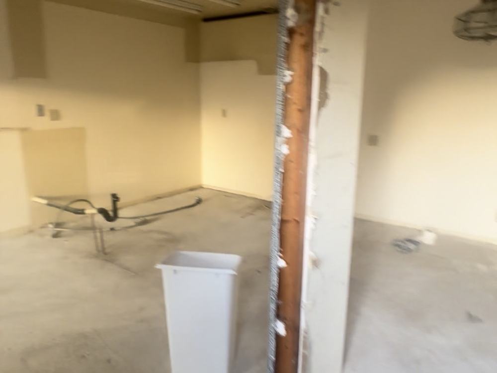 The same gutted kitchen swept and clear after removal